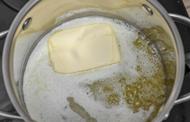 Clarify the butter in a pot, the butter cube melts the ice due to the temperature