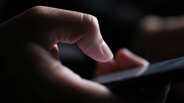 Person doomscrolling on a smartphone late at night in darkness, highlighting excessive screen time and digital addiction