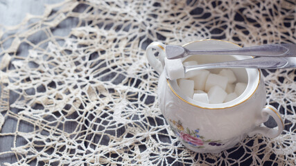 Porcelain sugar bowl and sugar tongs