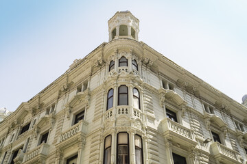 View of intricate, ornate white building facade rising against a clear sky, showcasing detailed architectural elements, Santander, Cantabria, Spain.