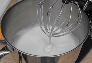 Foam of egg whites and sugar for a meringue cake, beaten in a food processor with a whisk