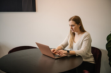 Investor broker analyzing indices. Young busy stressed business trader, analyst woman looking at laptop monitor feeling tired frustrated reading bad news on financial market working in home office.