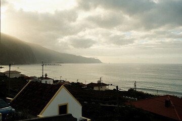 Coastal sunset scene, Serene dusk at rocky seaside with homes