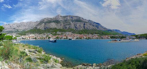 Panoramic view of the town of Makarska, Croatia, along the Adriatic Sea coast with the Biokovo mountains in the background