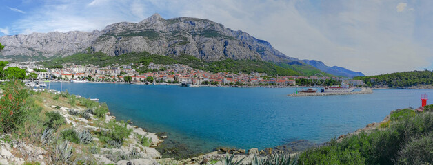 Panoramic view of the town of Makarska, Croatia, along the Adriatic Sea coast with the Biokovo mountains in the background