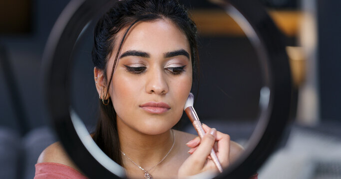 Makeup brush, woman and ring light for live streaming, beauty and tutorial for broadcast in home. Apply foundation, cosmetic influencer and aesthetic glow, shine and content creator with tips - Powered by Adobe