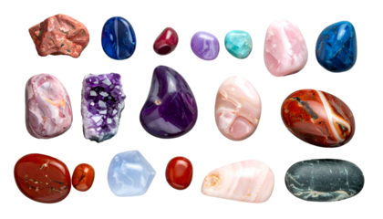A collection of polished gemstones arranged against a stark black background, showcasing an array of colors and textures