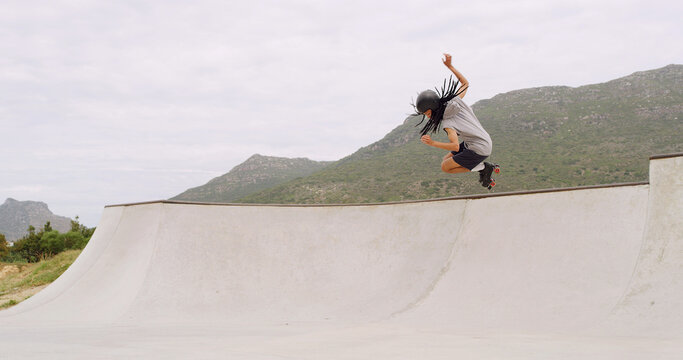 Man, roller skates and ramp at park with jump, sky and space with speed, skills or stunt in summer. Gen z person, skater and trick with exercise, energy or outdoor for extreme sports training in city
