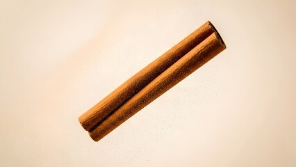 A close-up shot of a single cinnamon stick, showcasing its natural texture and warm brown color against a soft, neutral background, perfect for culinary and aromatic applications