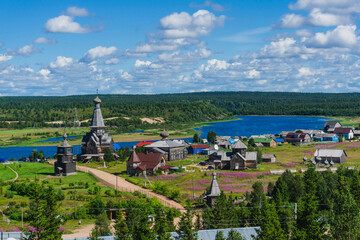 Scenic view of Varzuga village on Kola Peninsula, Russia &mdash; wooden churches, colorful houses and blue river under summer sky &mdash; professional landscape photography