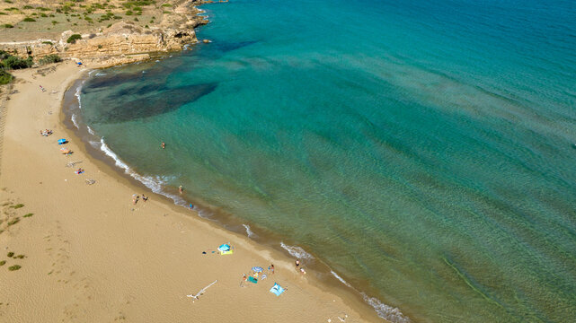 Aerial view of a beautiful sandy beach overlooking the Mediterranean Sea on a summer day. This is Eloro beach located in the Vendicari nature reserve in the province of Syracuse, Sicily, Italy.