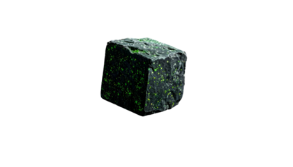 A dark gray mineral block features scattered bright green specks. The specimen is illuminated against a deep black backdrop, showcasing its textured surface