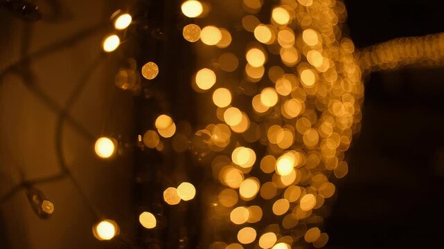 Shifting vertical warm string lights drifting right on balcony as camera pans, with coarse mesh
