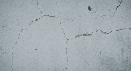 Fototapeta premium Close-up texture of a cracked concrete wall, highlighting imperfections and structural damage. Subtle gray background.