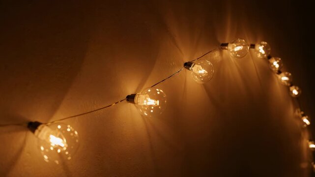 Drifting camera right revealing globe filament lights on painted wall, showcasing wire and sockets