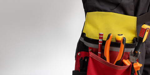 Close-up of worker, electrician in workwear. banner with place with text.