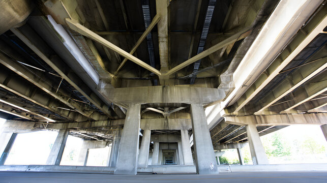 nationalizing. Massive bridge pillar supporting elevated roadway with architectural detail in daylight. real-estate listings.
