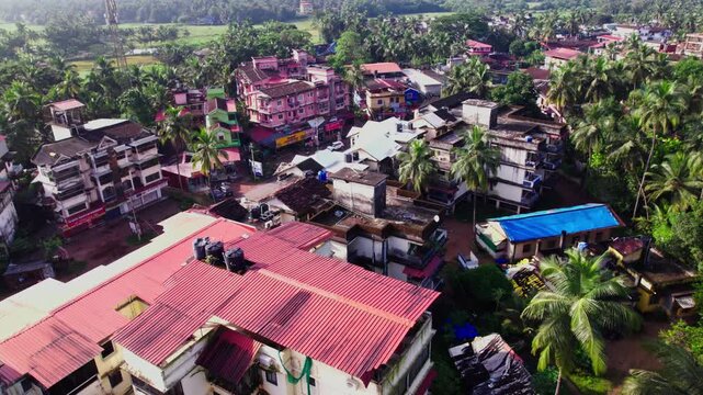 coastal village with Coconut trees and signal tower at colva, south goa, india. day time, jib shot, drone shot, 4k.