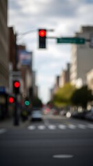 Blurry city street with red traffic light