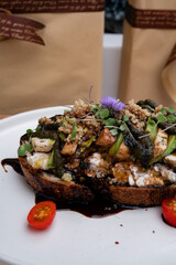 Artisan Culinary Creation: A culinary masterpiece unfolds, showcasing a meticulously crafted open-faced sandwich. Every detail reflects a fusion of flavors and textures.