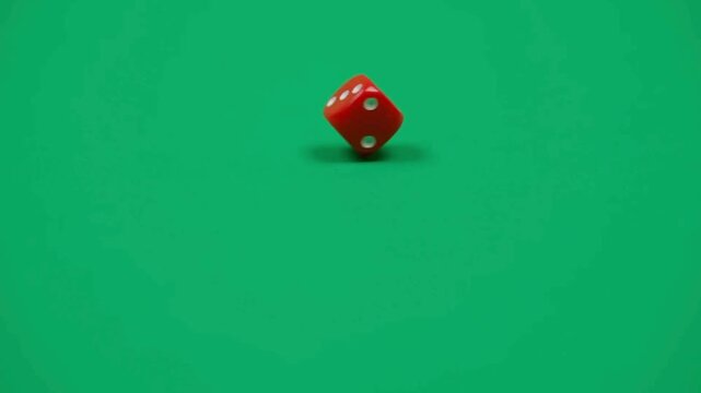 Red dice rolling on green surface in 4K, capturing dynamic motion, gaming concept, chance and luck symbolism, smooth tabletop action, and visually engaging playful and creative visuals.