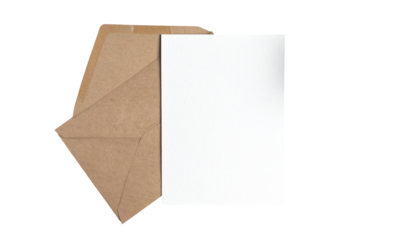 A blank white card rests slightly askew inside an open kraft paper envelope on black background