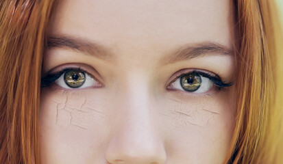 Woman with cracked on face as cosmetic and dehydration effect concept.