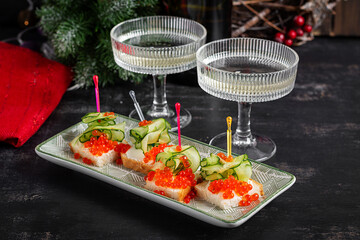 Christmas and New Year's dishes. Snacks and wine drinks for the holiday table. Canapes with red salmon caviar. Overhead