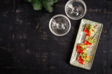 Christmas and New Year's dishes. Snacks and wine drinks for the holiday table. Canapes with red salmon caviar. Overhead
