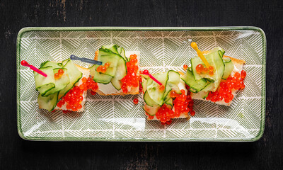 Christmas and New Year's dishes. Snacks and wine drinks for the holiday table. Canapes with red salmon caviar. Overhead