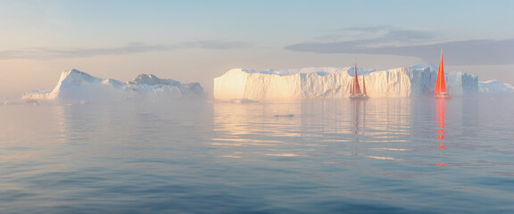 Little red sailboat cruising among floating icebergs in Disko Bay glacier during midnight sun season of polar summer. Ilulissat, Greenland. Unesco world heritage. Global warming and climate change.
