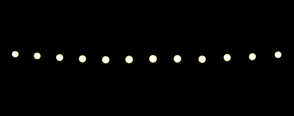 Small bright light points are arranged in a straight horizontal line on a black background. The