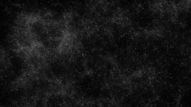 Black grunge texture overlay with fine white dust particles and noise
