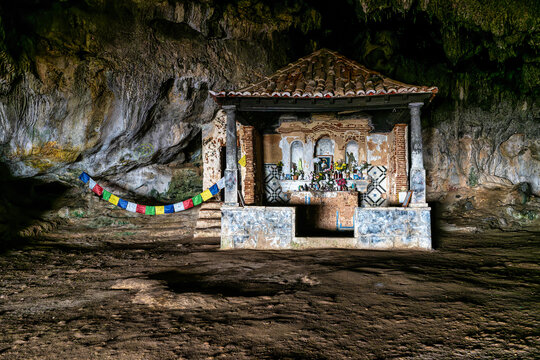 Dark interior of Lapa de Santa Margarida in Arrabida, Setubal, Portugal. Cave with small chapel of spontaneous worship