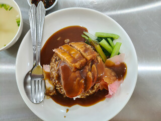 Top view of red pork and crispy pork rice on the table, a delicious Thai dish.