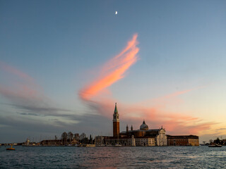 The moon and a pink cloud shaped like an angel's wing above the island of San Giorgio Maggiore in Venice. Taken from the Riva degli Schiavoni.