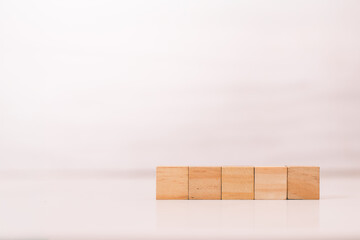 Minimalist Row of Empty Wooden Blocks for Business Growth and Planning on White Background