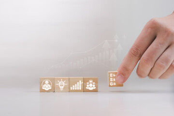 Business Start Up and Growth Concept: Hand Placing Last Wooden Block in a Row on White Background