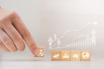 Hand Placing Recycle Block for Sustainable Growth and Circular Economy Concept