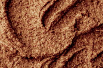 Chocolate ice cream with nuts and banana, texture. Chocolate smoothie cocktail close-up. Nut paste as a background.