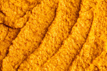 Smoothie of fresh fruits and berries, orange, banana, mango, sea buckthorn, cloudberry. Ice cream texture. Fruit yogurt ice cream. Delicious sweet dessert close-up as a background.