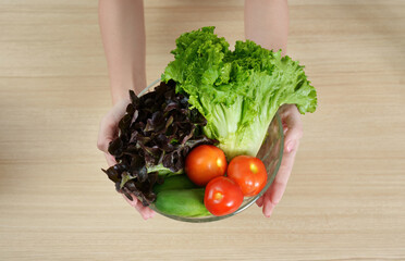 Healthy Eating. Woman holding a bowl of fresh vegetables with a smile.