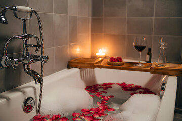 Solo self care a bathtub with bubbles and rose petals