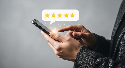 Person holding smartphone with five star rating appearing above screen hand stars