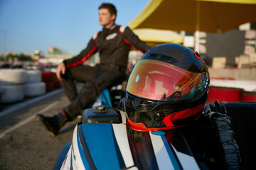 A racer poses confidently next to a gokart © Nomad_Soul