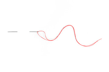Sewing needle with red thread through the white background	
