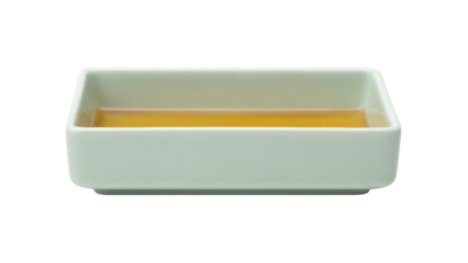 Light green square bowl with yellow liquid isolated PNG, minimalist tableware for food presentation and culinary design projects