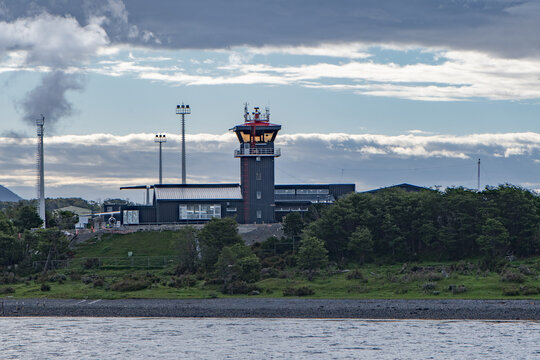 Aerial view of the modern architecture of the Guardiamarina Za&Atilde;&plusmn;artu Airport's control tower, its dark facade contrasting with the overcast sky, Puerto Williams, Chile.
