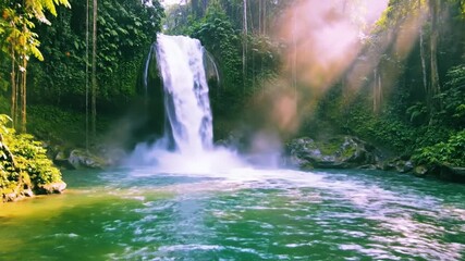 Sun-drenched mist rises from the powerful cascade in this stunning, vibrant jungle paradise.