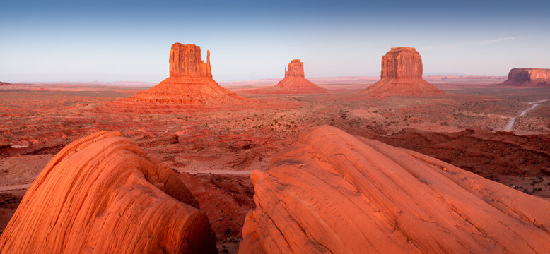 Dramatic view of the Monument Valley's magnificent butte and mittens lit up during a sunset.
Iconic butte, spire and mitten formations used as a backdrop in many old western movies. Navajo,Arizona.